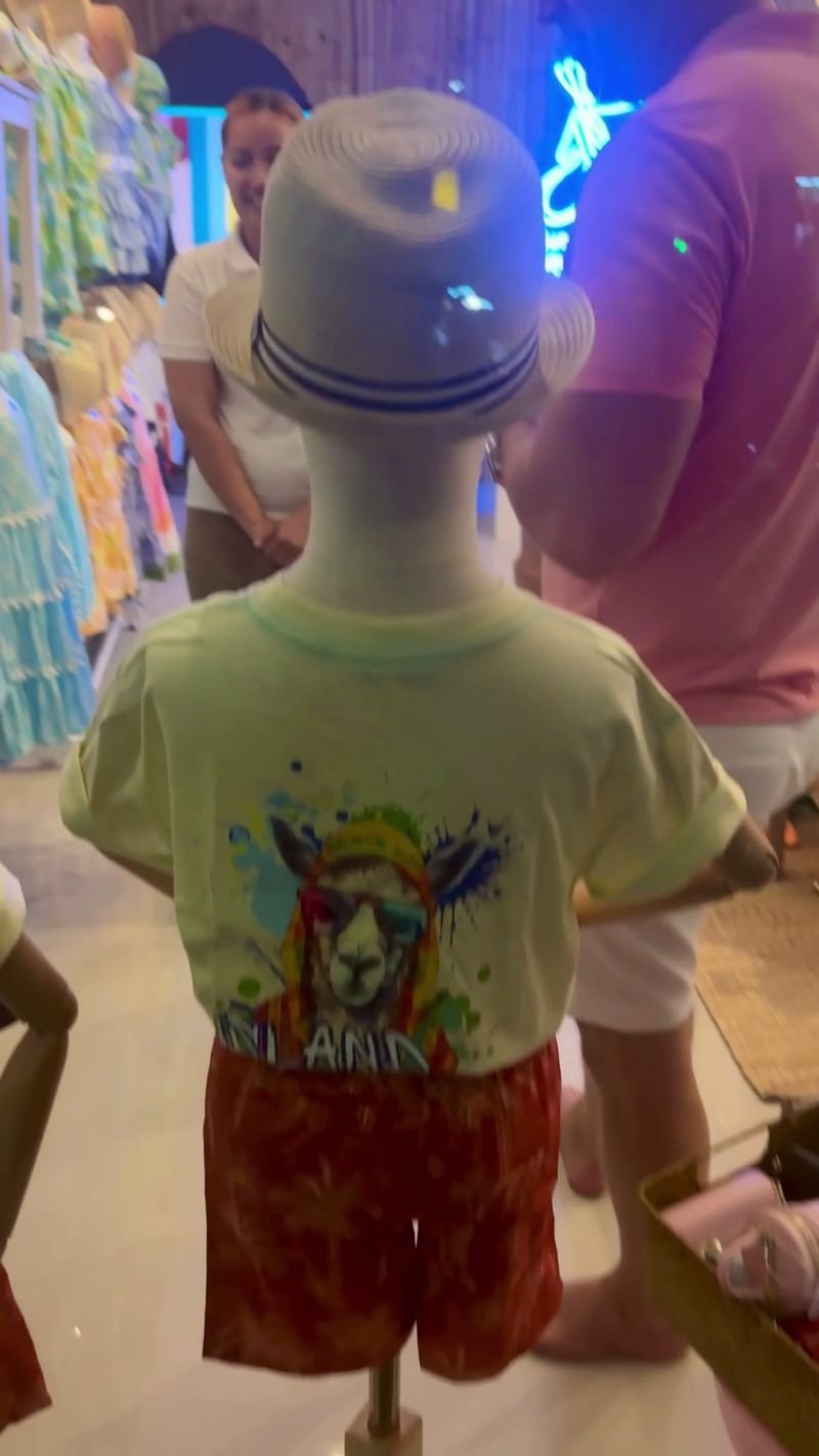 Boy with a sun hat and printed T-shirt looking at the racks
