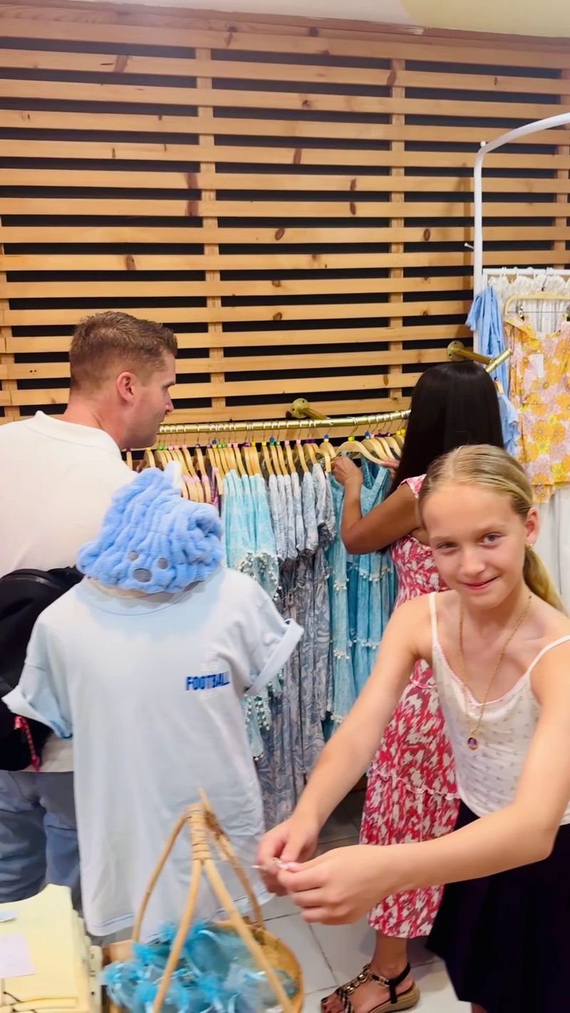 Family browsing the racks at Anjuna Kids